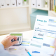 Man calculating electric bill statement and home energy consumption