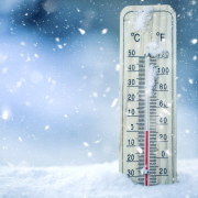 Thermometer on snow shows low temperatures in celsius or farenheit