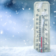 Thermometer on snow shows low temperatures in celsius or farenheit